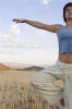 Woman doing Tai Chi in corn fields