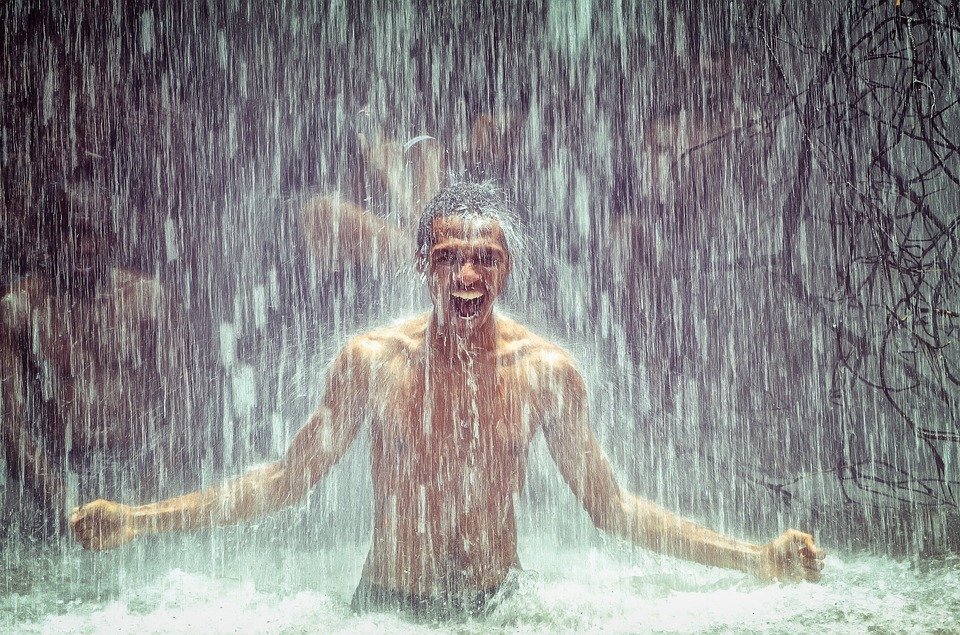 Man under waterfall