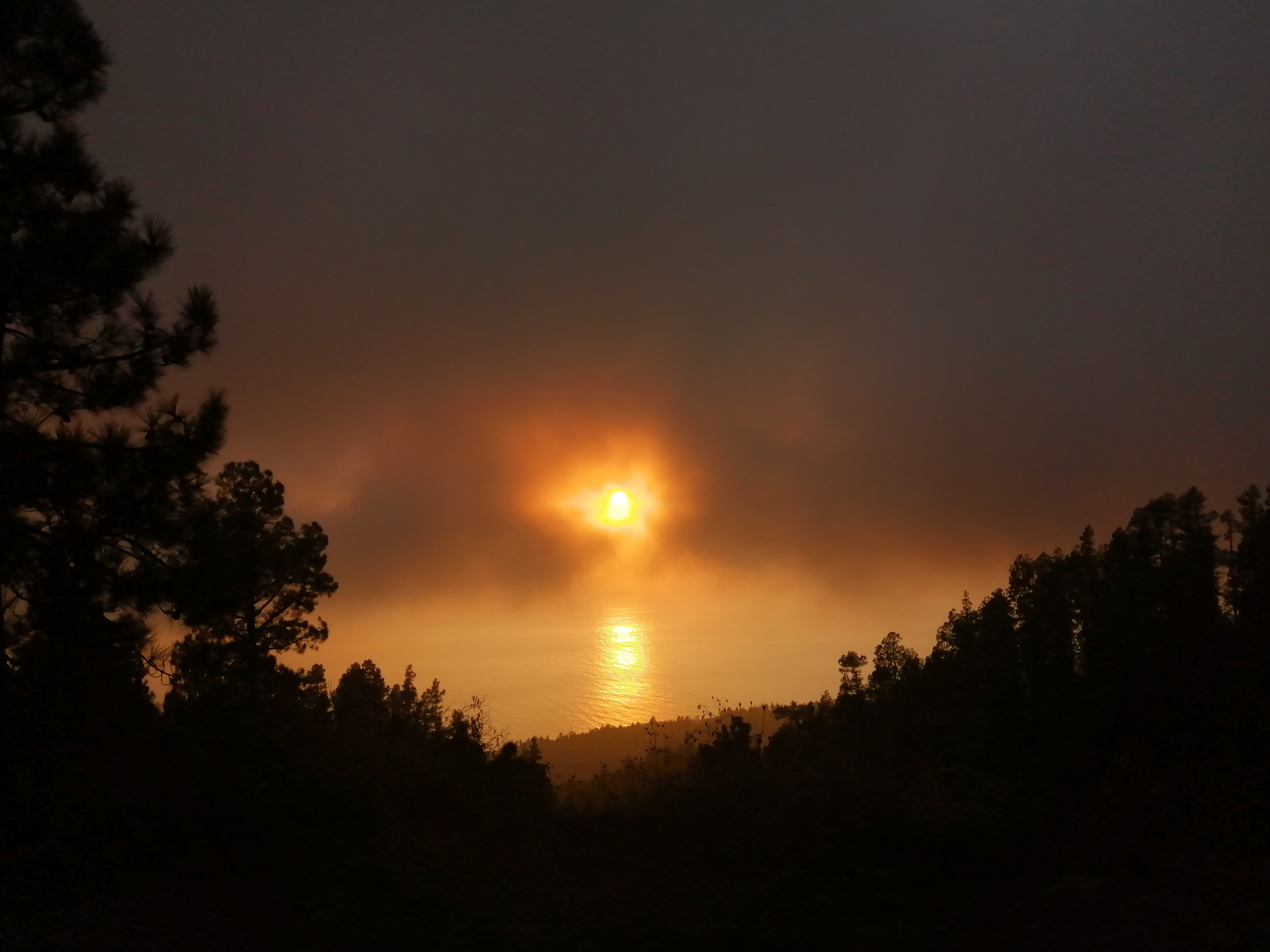 smoke enveloping the setting sun